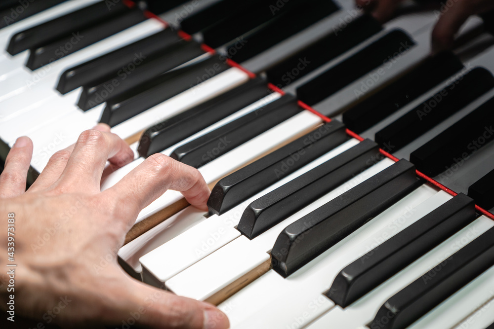 Obraz premium Piano keys on classical grand piano - closeup of piano keyboard for pianist, concert, music production and recording concept