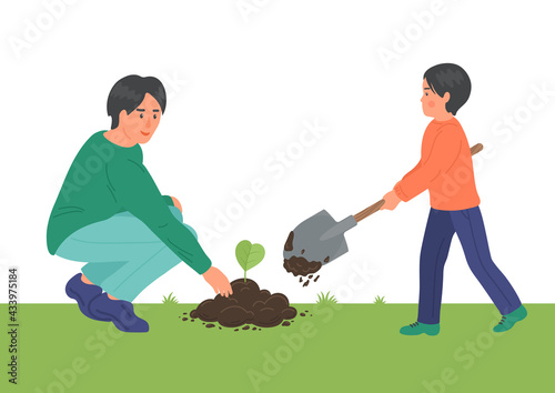 Father with boy planting heart form plant. Happy family working in the garden. Environment, ecology, earth care concept. 