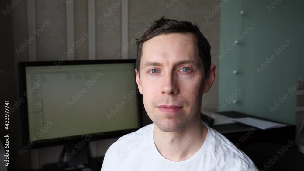 Man in white dress. Slow video portrait. Home office businessman. Caucasian male person sitting near computer. Emotion on programmer face. Coding web site Man in white dress. Slow video portrait. Home office businessman. Caucasian male person sitting near computer. Emotion on programmer face. Coding web site