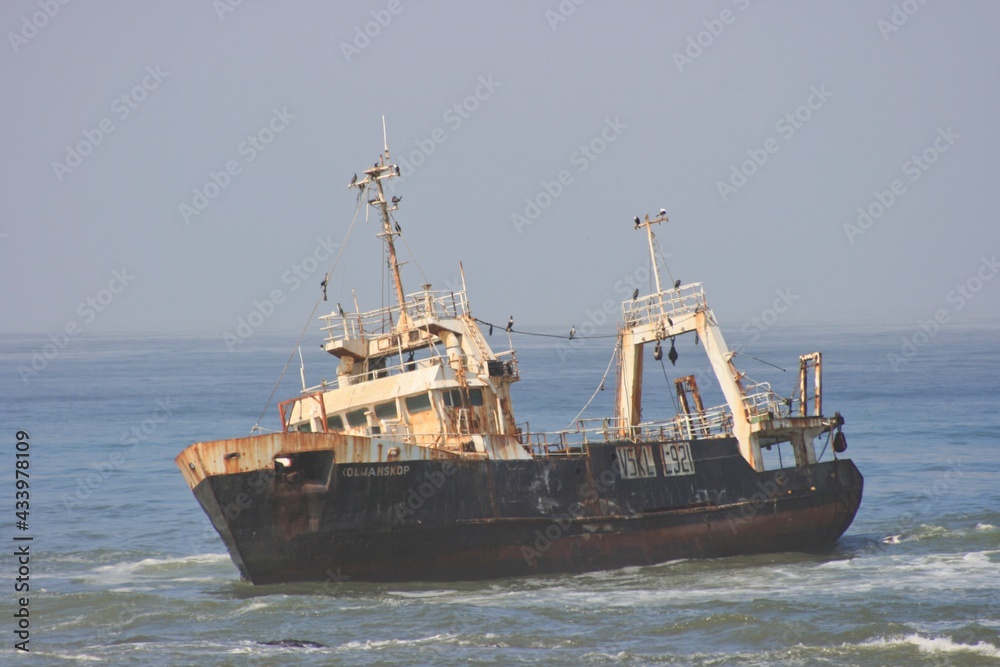 Abandoned ghostly shipwreck above water along Skeleton Coast, Nambia. Abandoned ghostly shipwreck above water along Skeleton Coast, Nambia.