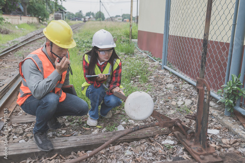 Two engineer working at train station,Work together happily,Help each other analyze the problem,Consult about development guidelines