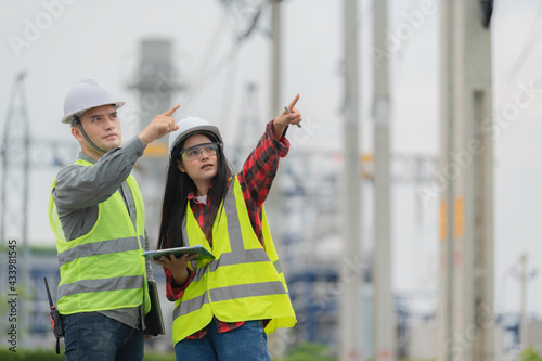 Two engineer working at power plant,Work together happily,Help each other analyze the problem,Consult about development guidelines