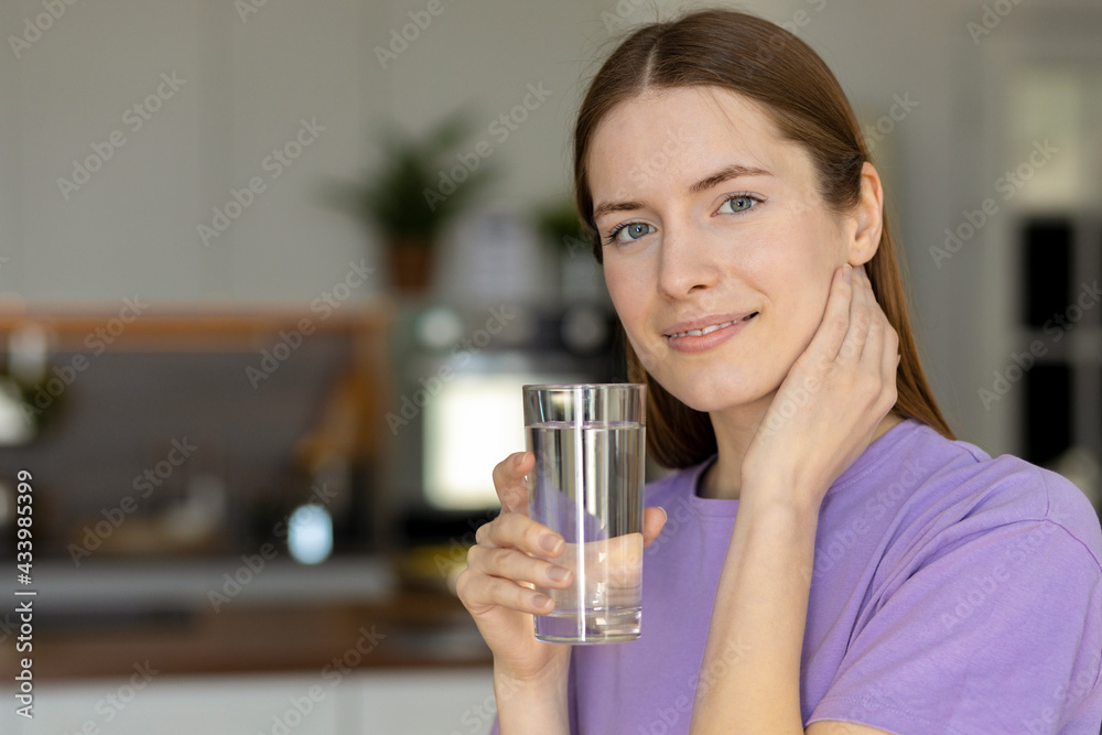 Healthy lifestyle. Portrait young girl enjoying refreshing drink, copy space. Beautiful woman drinking mineral water in home Kitchen. Healthy lifestyle. Portrait young girl enjoying refreshing drink, copy space. Beautiful woman drinking mineral water in home Kitchen.