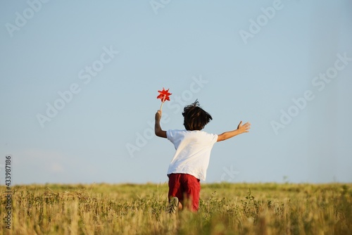 Happy kid running on beautiful field