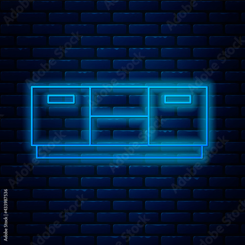 Glowing neon line Furniture nightstand icon isolated on brick wall background. Vector