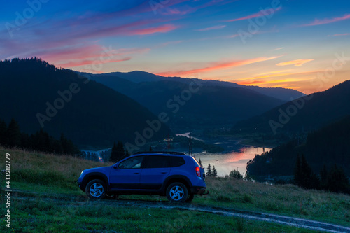Off Road car in mountain sunset landscape, Romania