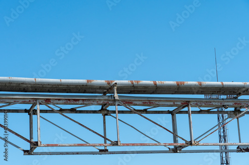 Pipes and other metal structures close-up. Flue gas emissions and atmospheric air pollution. Horizontal gas exhaust pipes on the territory of the factory