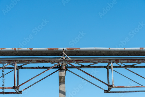 Pipes and other metal structures close-up. Flue gas emissions and atmospheric air pollution. Horizontal gas exhaust pipes on the territory of the factory