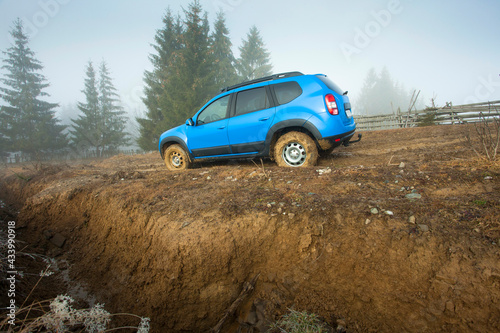 blue car with mud in off road