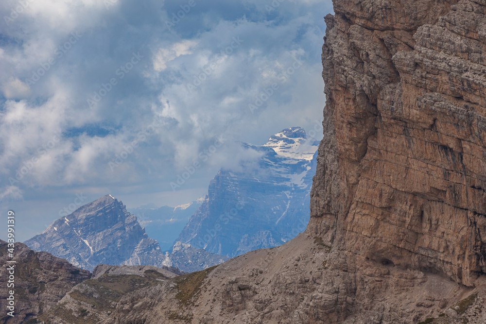 View of the imposing southern face of Mount Duranno with Mount Pelmo summit background, Dolomites, Italy