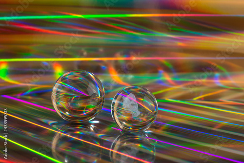 Glass crystal balls on abstract holographic background close up. 