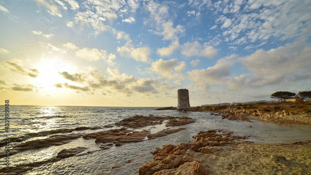 sunset on the beach of sardegna with torre