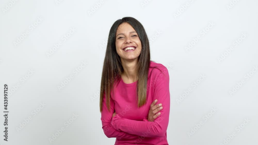 Young woman keeping the arms crossed while smiling over isolated background Young woman keeping the arms crossed while smiling over isolated background