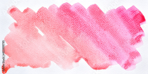 a photo image of abstract red and pink watercolor on paper, hand paint of red and pink watercolor gradient for background, wet technique on paper to mix difference color