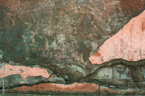 Texture of an abandoned wall with damaged plaster.