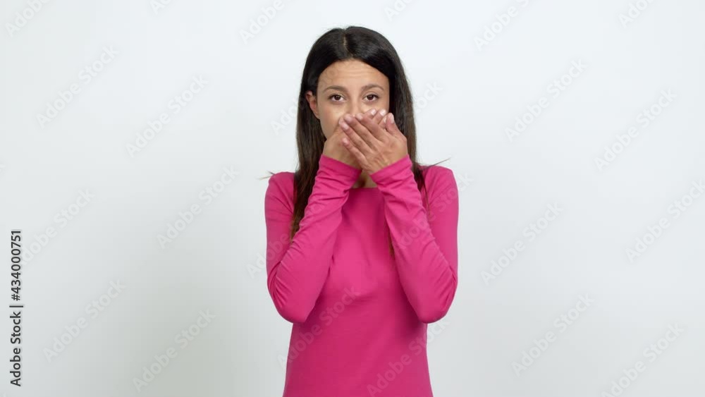 Young woman covering mouth with hands. Can not speak over isolated background Young woman covering mouth with hands. Can not speak over isolated background