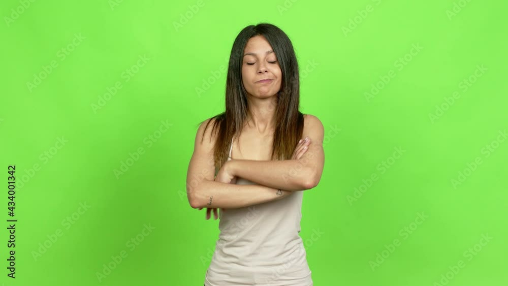 Young woman making unimportant and doubts gesture while lifting the shoulders and the palms of the hands over isolated background