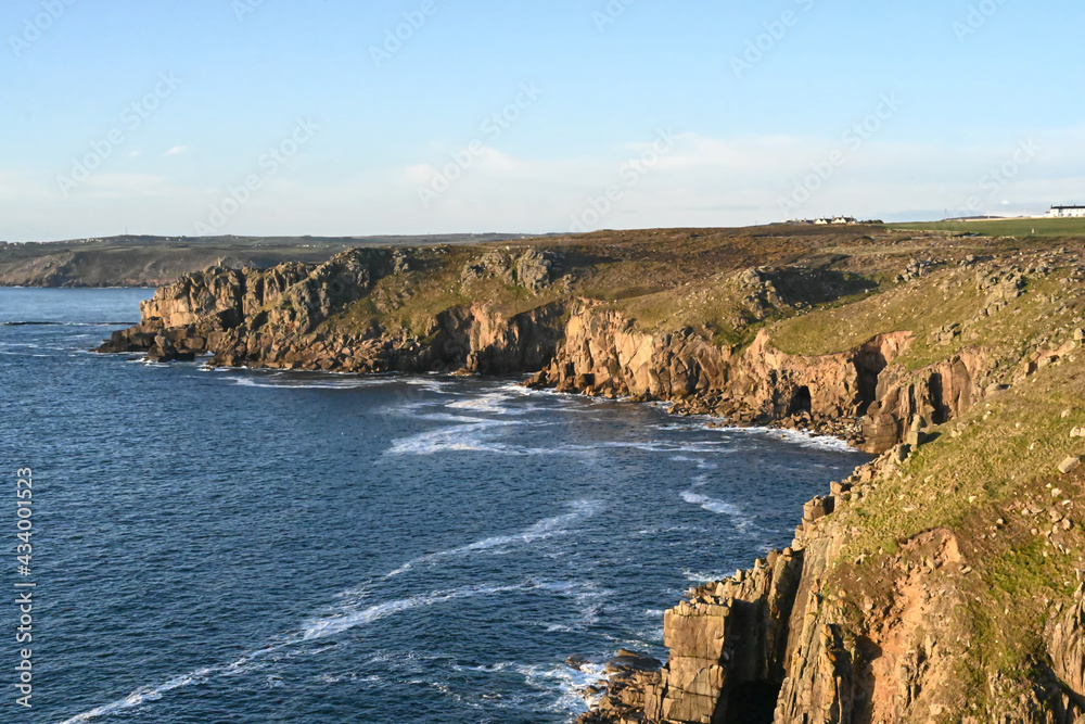 beautiful coast with cliffs and rocky bay on a summer day with blue skies, taken at lands end in Cornwall