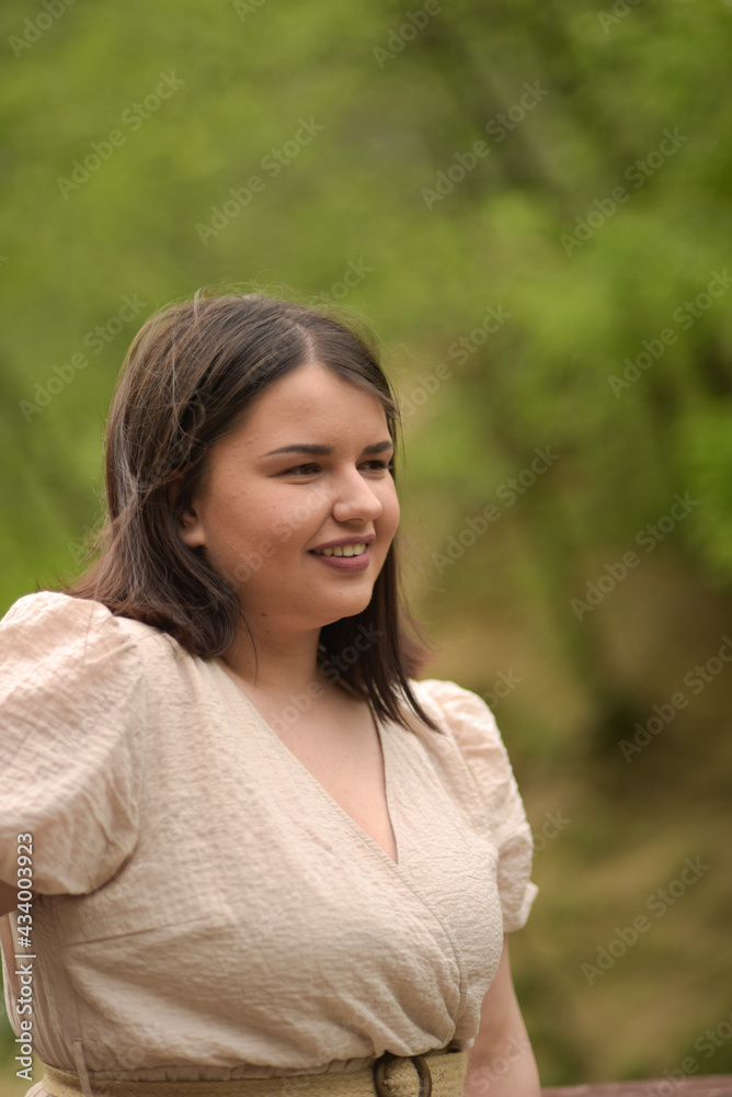 Young girl with a beautiful smile in nature
