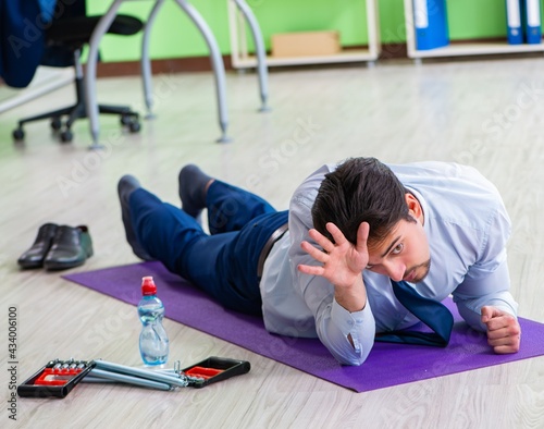 Employee doing exercises during break at work © Elnur