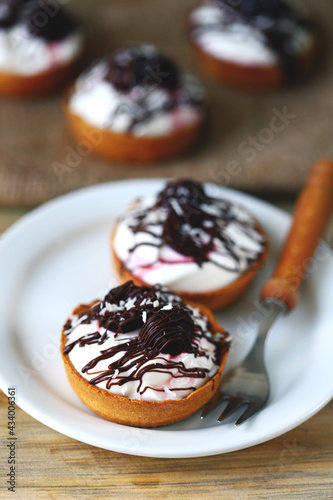 Delicious tartlets with cream cheese, chocolate and cherries. Healthy dessert with curd cheese. Mascarpone dessert. Keto dessert.