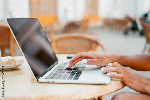 A young woman is working typing a message to the partners ' email. Applies for a loan on the bank's website. Online training.