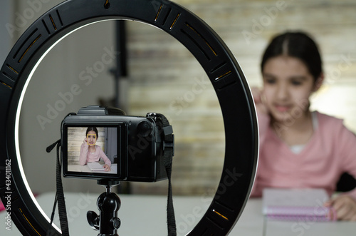 Latin Girl Recording Vlog Video Blog At Home With Camera,wooden background and ring light