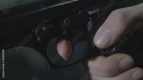 young man raises the gun and pulls the trigger