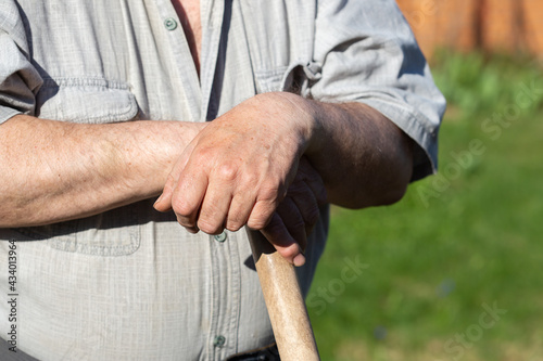 Senior Man Hands holding a garden tool
