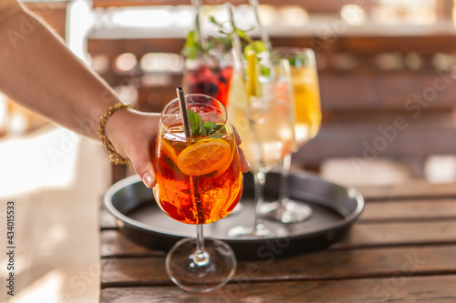 Close-up of delicious alcoholic summer cocktails on a wooden table in the summer outdoors	
