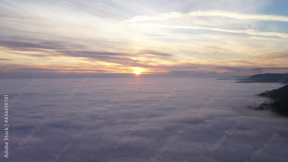 Beautiful fiery sunset beyond a sea of clouds - aerial Beautiful fiery sunset beyond a sea of clouds - aerial
