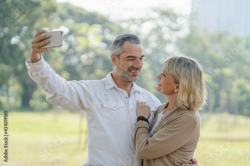 Mature couple take a selfie photo during vacation