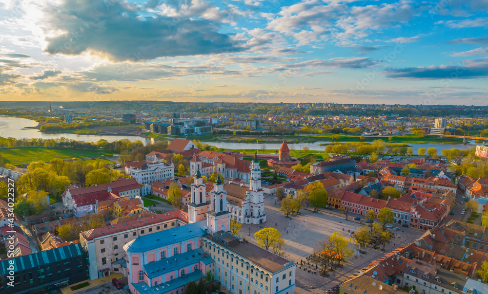 Aerial view of a sunny day in Kaunas city town hall square with towers of churches, castle, cathedral and Neris river around