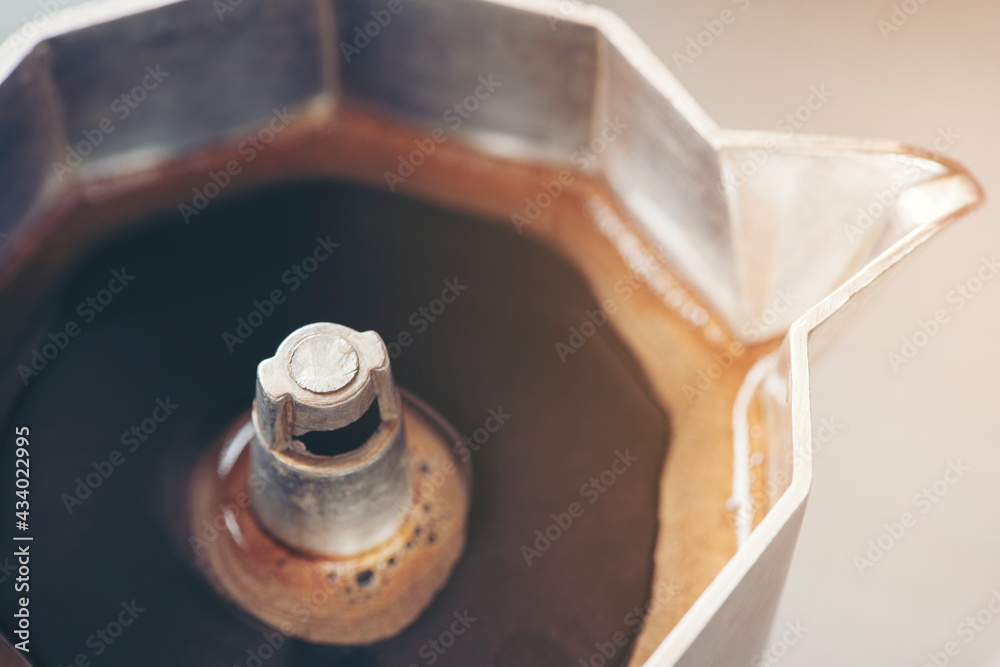 Close up coffee brewing in Italian espresso maker moka pot Close up coffee brewing in Italian espresso maker moka pot