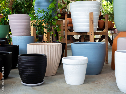 Various colorful plant pots in the shop. photo