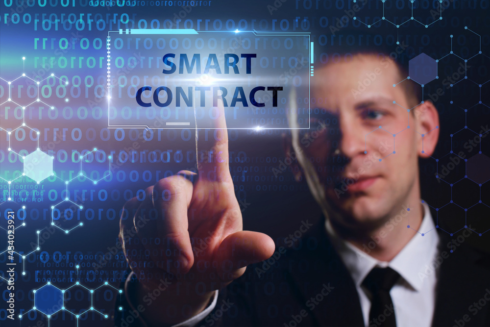 Business, Technology, Internet and network concept. Young businessman working on a virtual screen of the future and sees the inscription: Smart contract Business, Technology, Internet and network concept. Young businessman working on a virtual screen of the future and sees the inscription: Smart contract