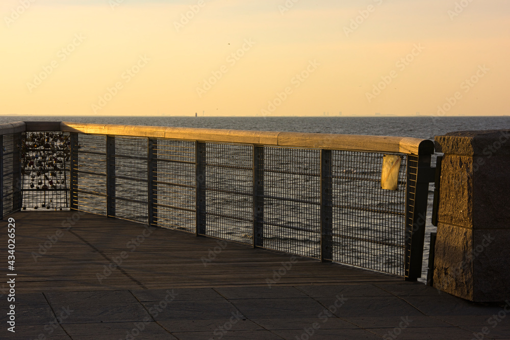 210501 Malmo Sweden - Sunset over pier of love locks. High quality photo