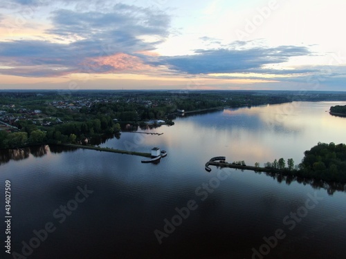 Aerial view sunset on the river. Colorful clouds are reflected in the water. Beautiful panorama of nature at sunset.