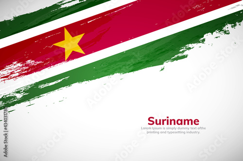 Brush painted grunge flag of Suriname country. Hand drawn flag style of Suriname. Creative brush stroke concept background