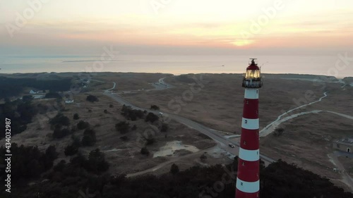 Droneshot of a red and white lighthouse on the island Ameland in Netherlands photo