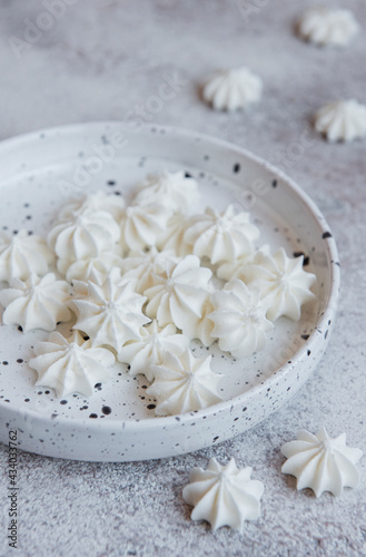 Small white meringues in the ceramic bowl