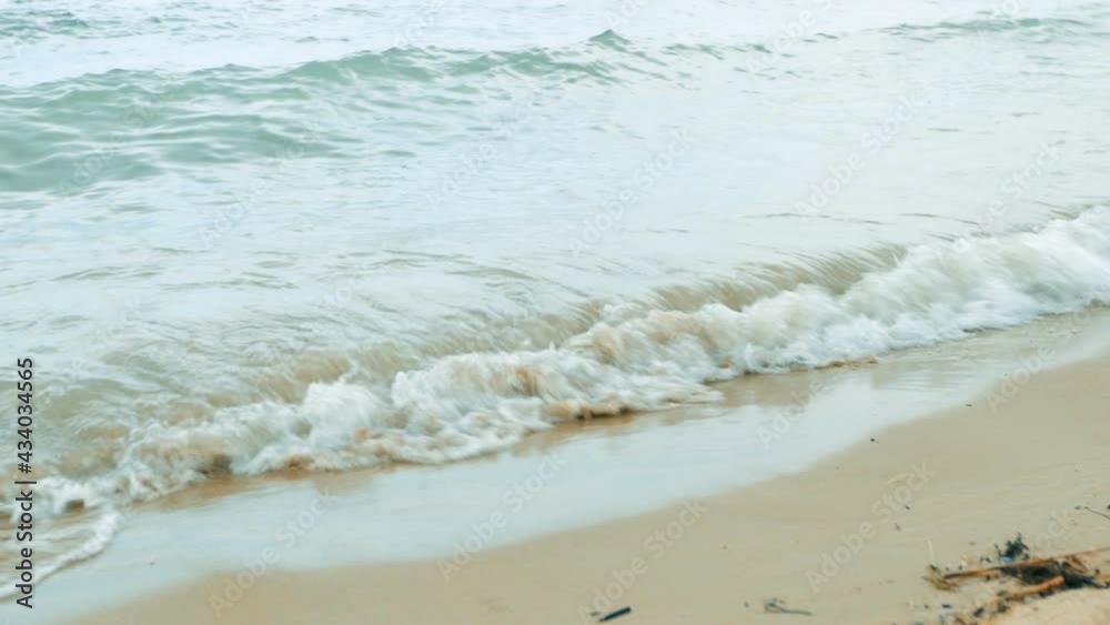 Bride in a white dress walking barefoot along the beach Bride in a white dress walking barefoot along the beach