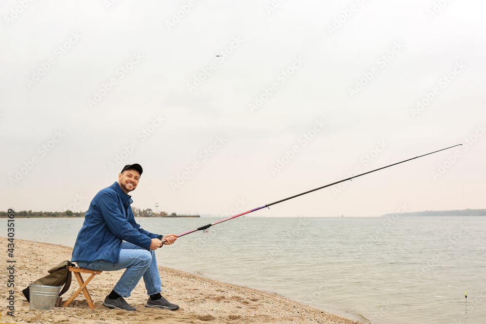 Man fishing on river bank Man fishing on river bank