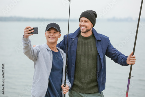 Happy father and son taking...