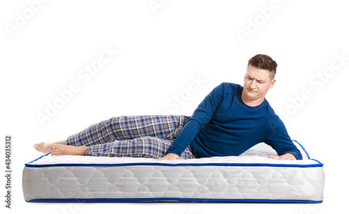 Young man lying on mattress...