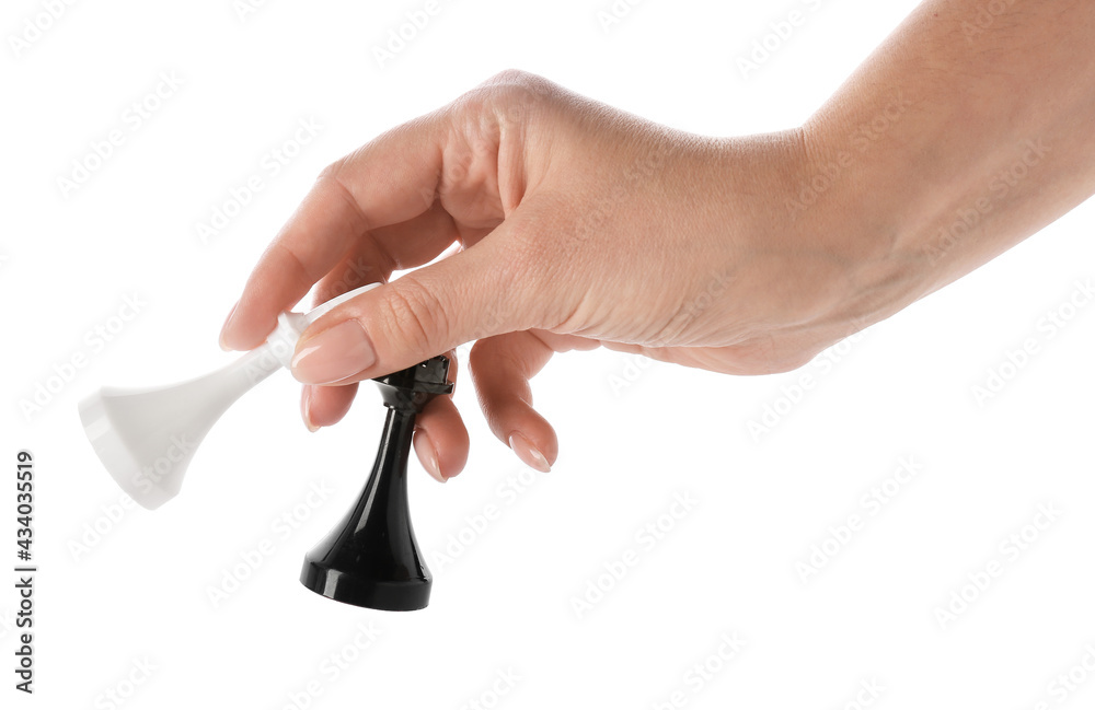 Female hand with chess pieces on white background Female hand with chess pieces on white background