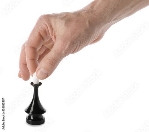 Male hand with chess piece on white background