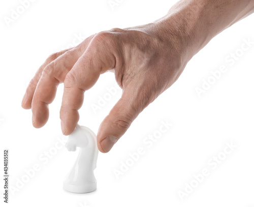Male hand with chess piece on white background © Pixel-Shot