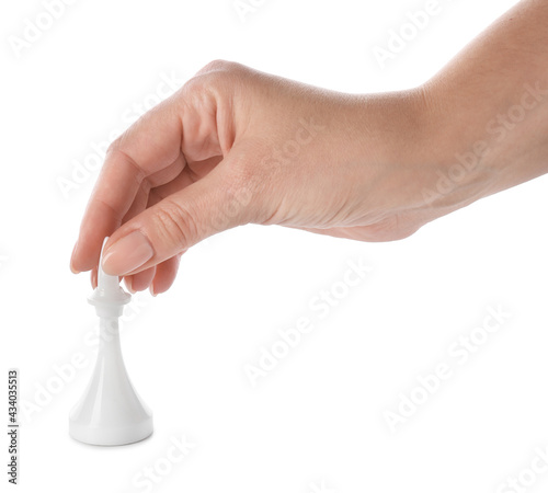 Female hand with chess piece on white background