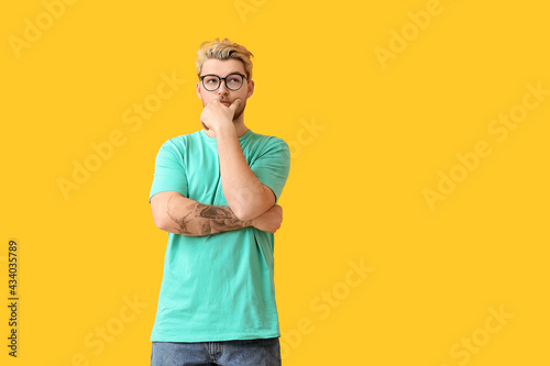 Thoughtful young man wearin...